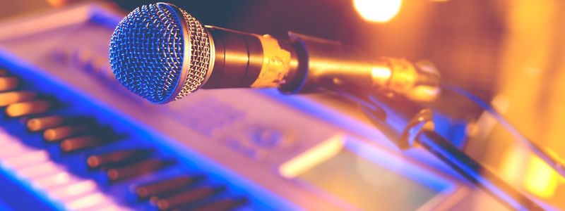 A microphone above an electric keyboard.