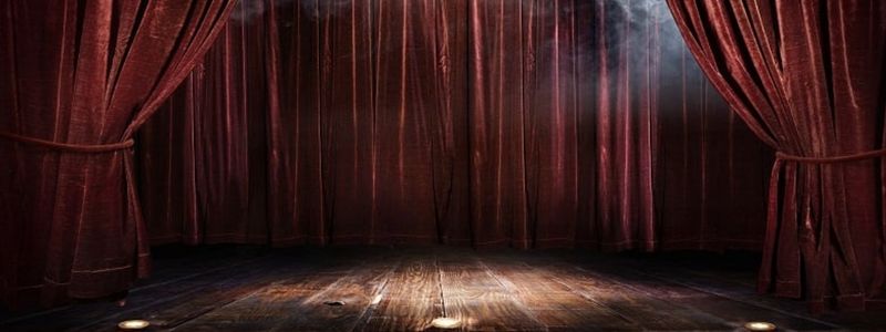 Theatre curtains and an empty stage.