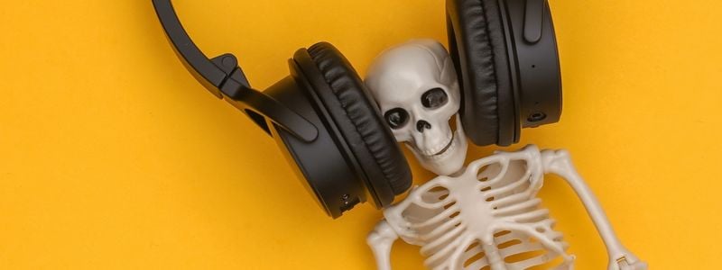 A skeleton with large headphones on.