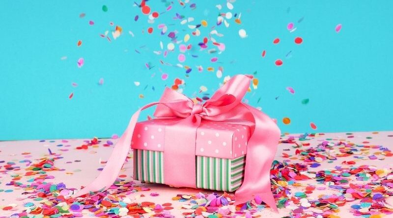 A pink gift with confetti.