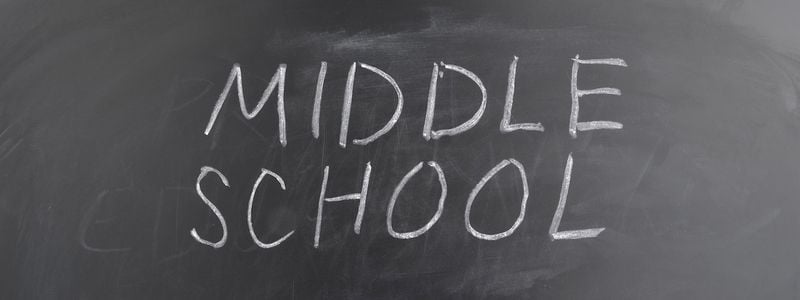 The words "Middle School" written on a chalkboard.