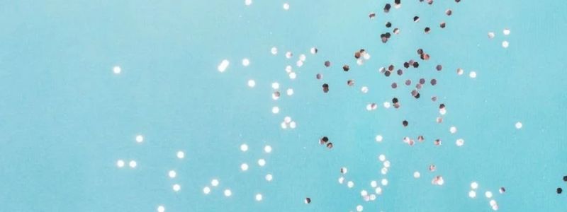 Silver confetti on a blue background.