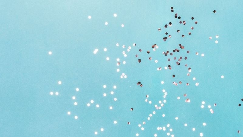 Silver confetti flying through the air.