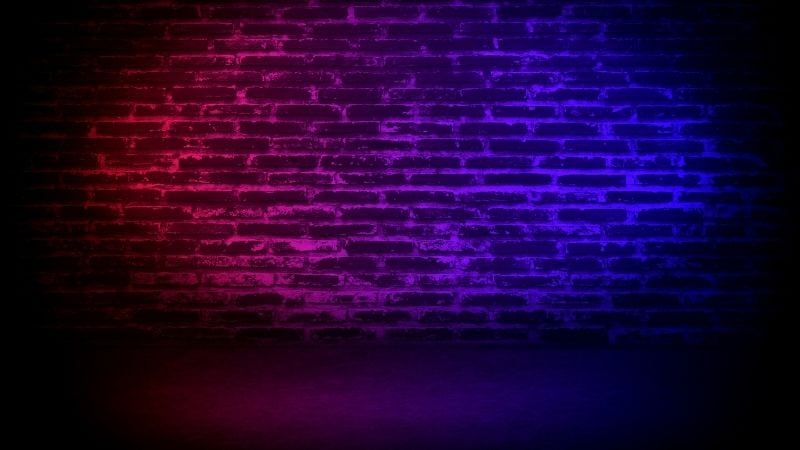 A neon brick stage wall.