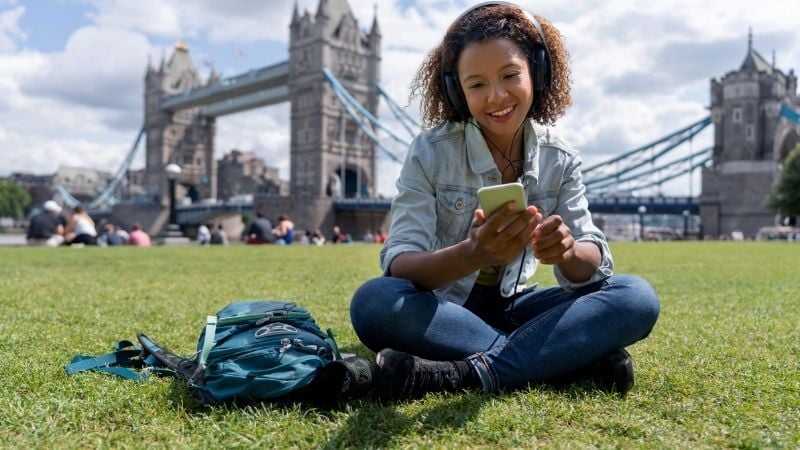 A woman listening to music in London.