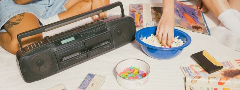 1990s sleepover vibes with snacks and a tape player.