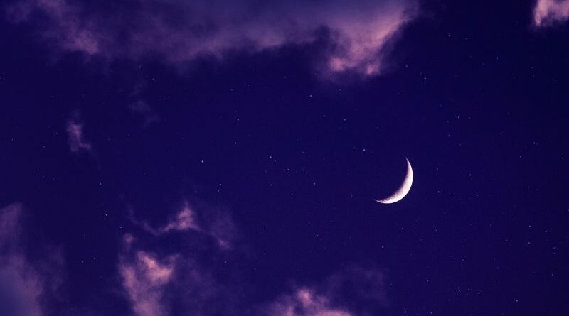 A purple sky with a crescent moon.