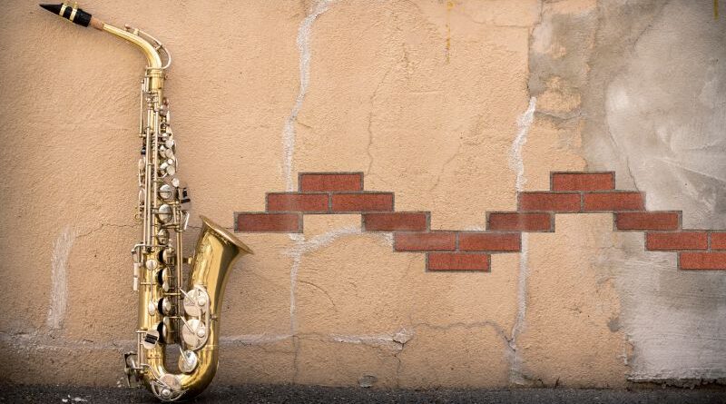 A saxophone against a wall.
