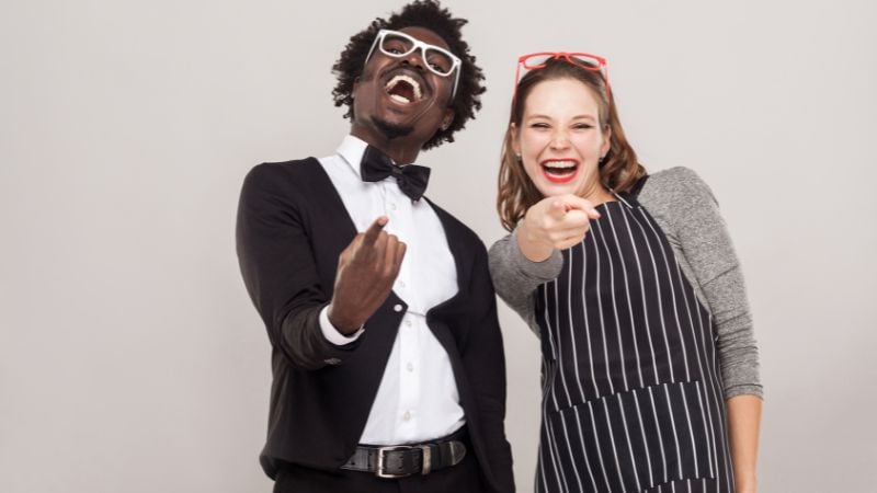 Two people laughing at someone.
