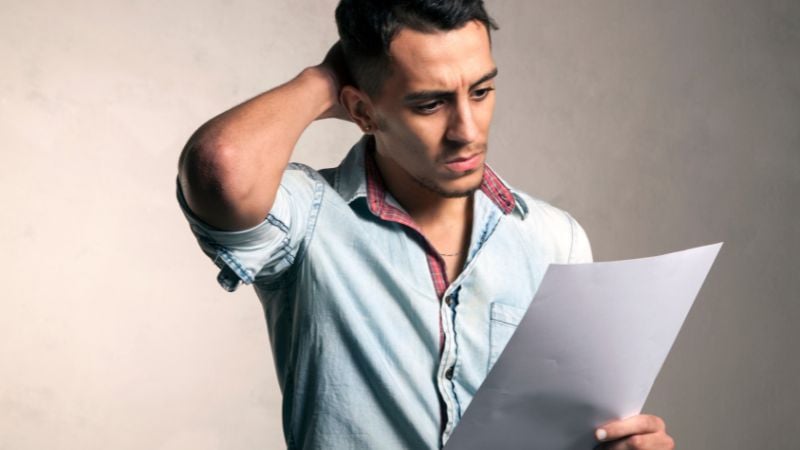 A man looking over a list of obscure musicals.