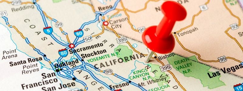 A map of California with a push pin in it.