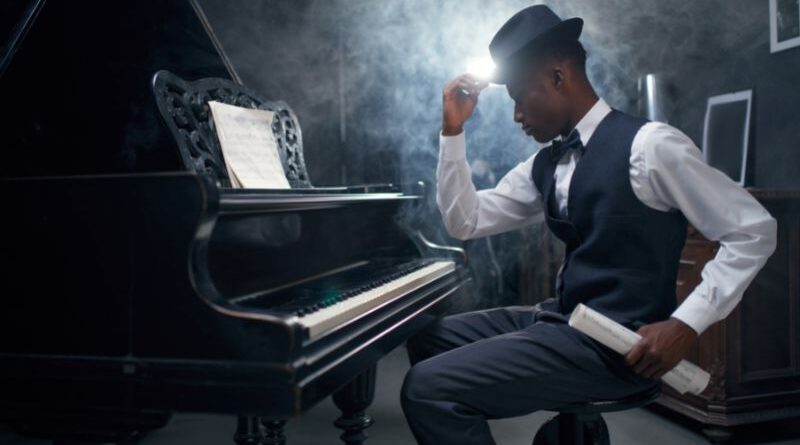 A Black composer at the piano.