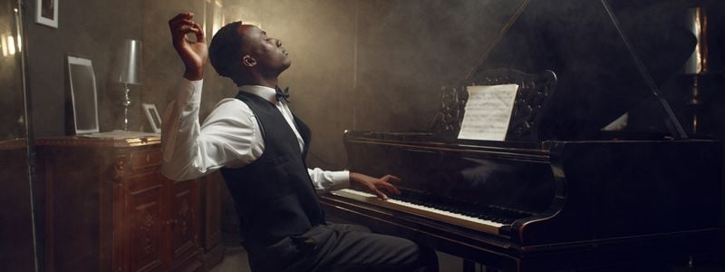 A Black composer at the piano.