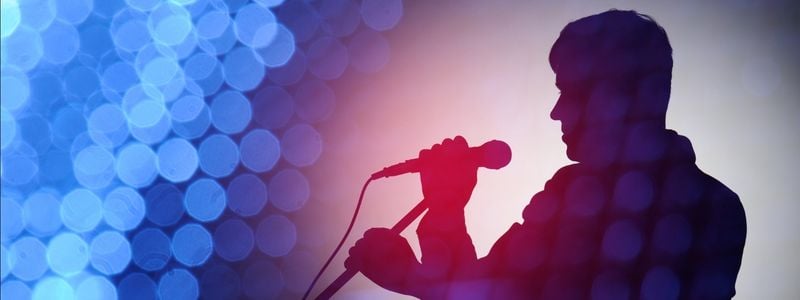 A silhouette of a pop/rock singer.