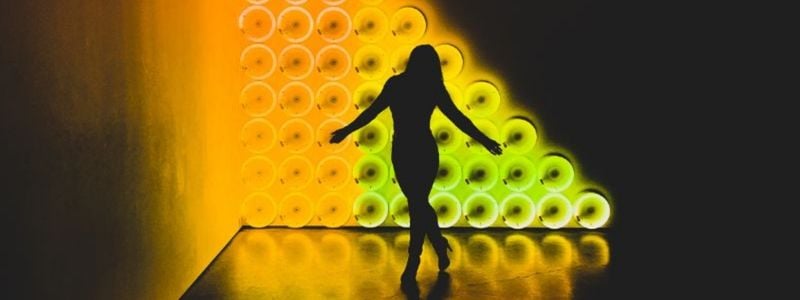 A performer on a yellow abstract stage.