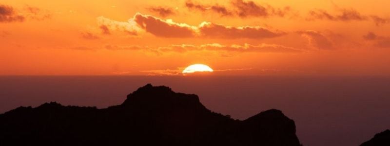 Mountains and an orange sunset.