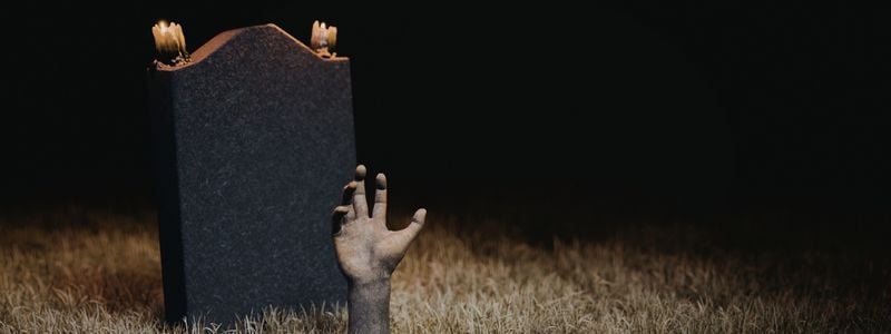 A zombie hand in a grave.