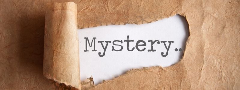 The word "mystery" typed on a peeled back paper.