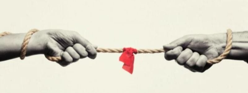 Two hands tugging at a rope.
