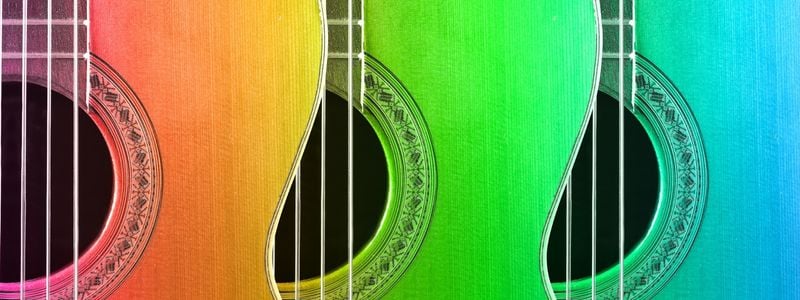 Three colorfully lit guitars.