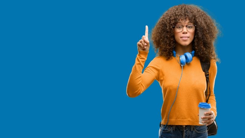 Someone listening to music and holding up one finger.