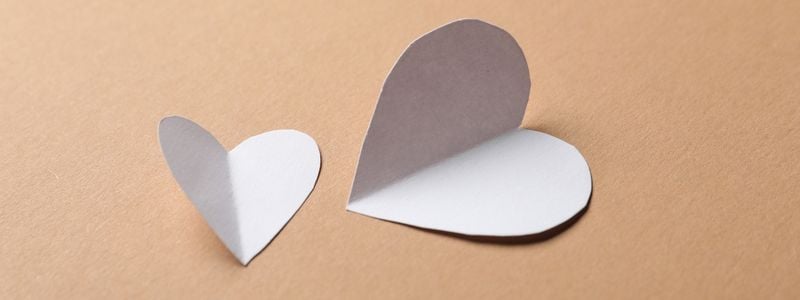 Two paper heart cutouts.