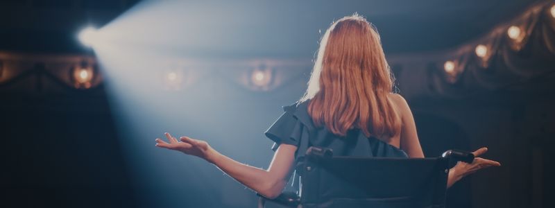 The back of an actress on stage.