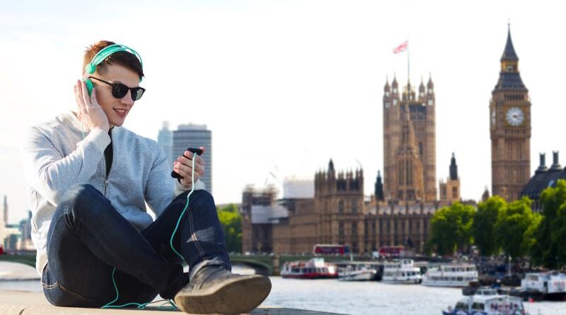 A young person listening to music in London.