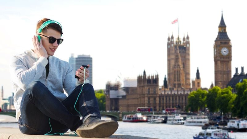 A young person listening to music in London.