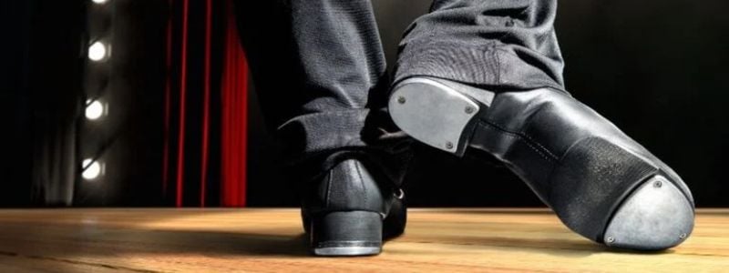 Tap shoes on a stage.