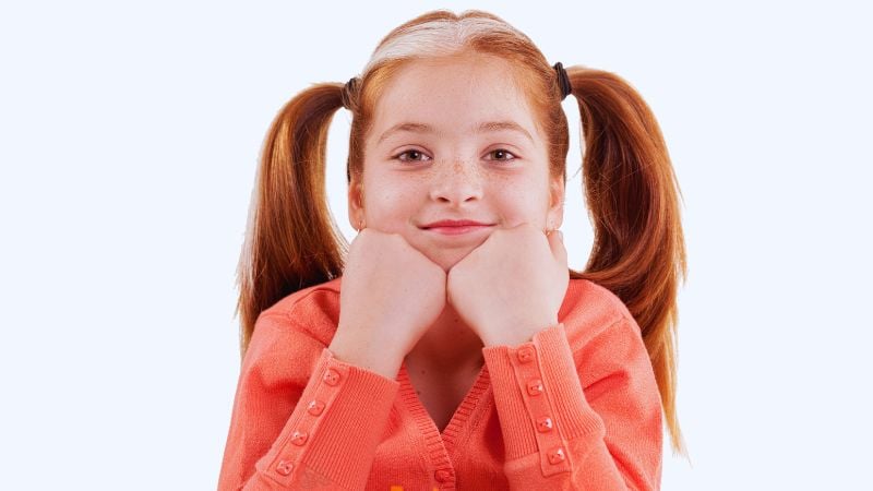 A girl with freckles and pigtails.