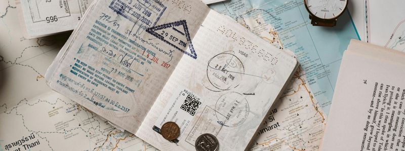 A used passport, map, and compass.