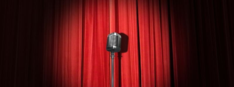 A microphone in the spotlight on stage.