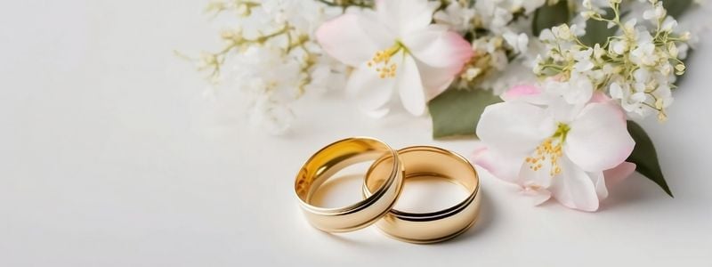 Two wedding rings next to wedding flowers.