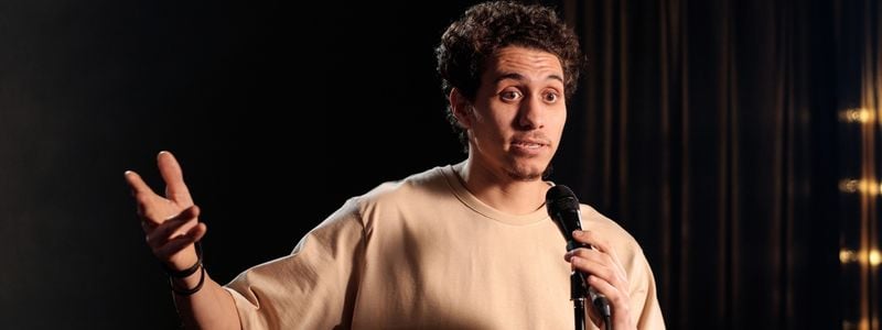 A man narrating on stage.