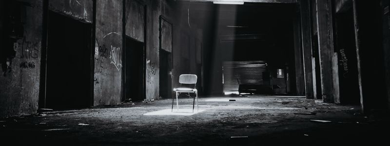 A chair on a dark stage.