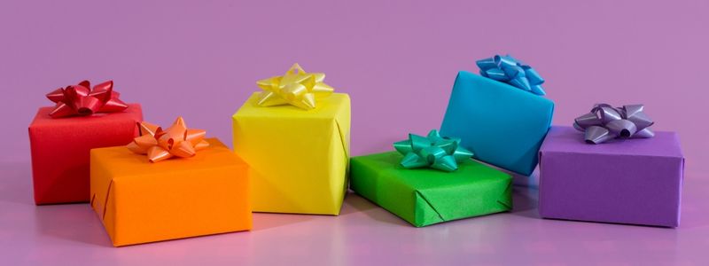 Rainbow gifts on a purple background.