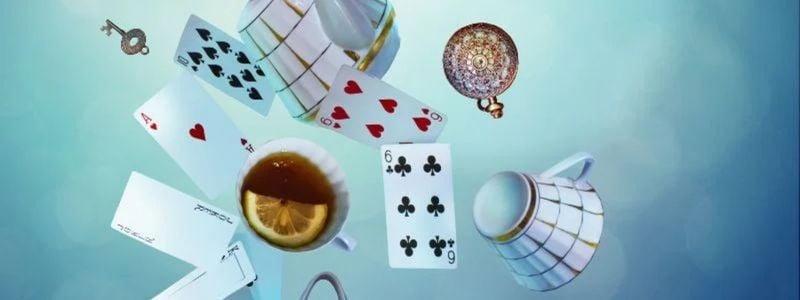 Cards, tea, and clocks falling through a blue space.