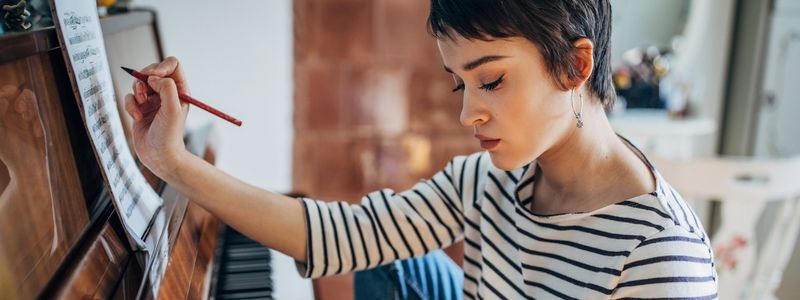 A composer at the piano.