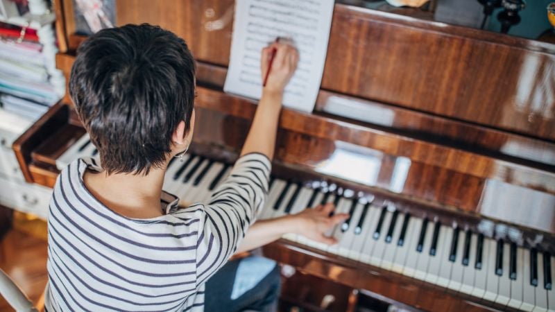 A composer at the piano.