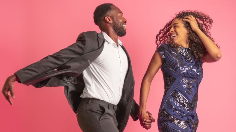 A couple holding hands and smiling.