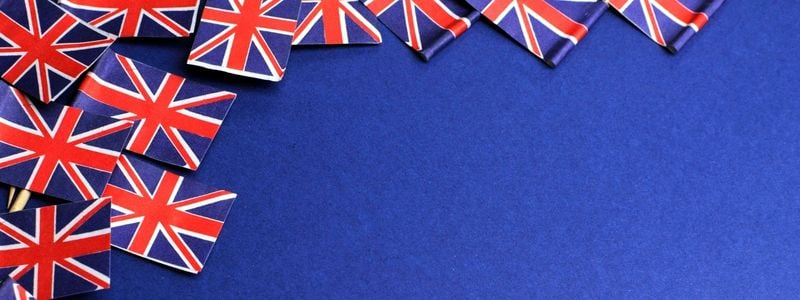 Tiny Union Jack flags on a blue background.