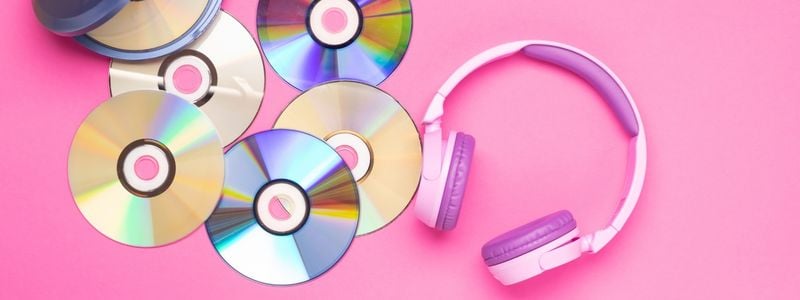 Big pink headphones and 2000s style CDs.