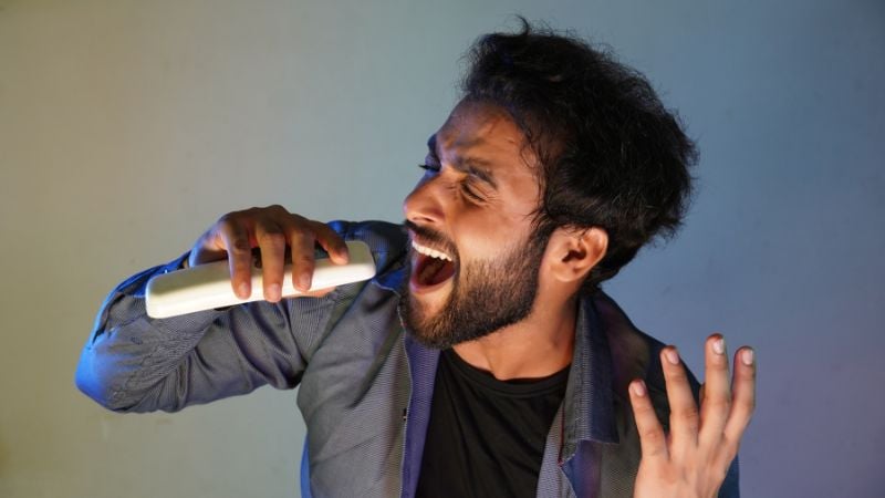 A tenor singer singing a high note.