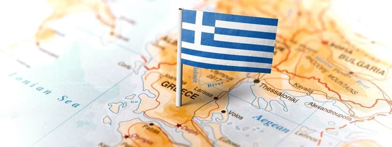 A map of Greece with a Greek flag marking it.