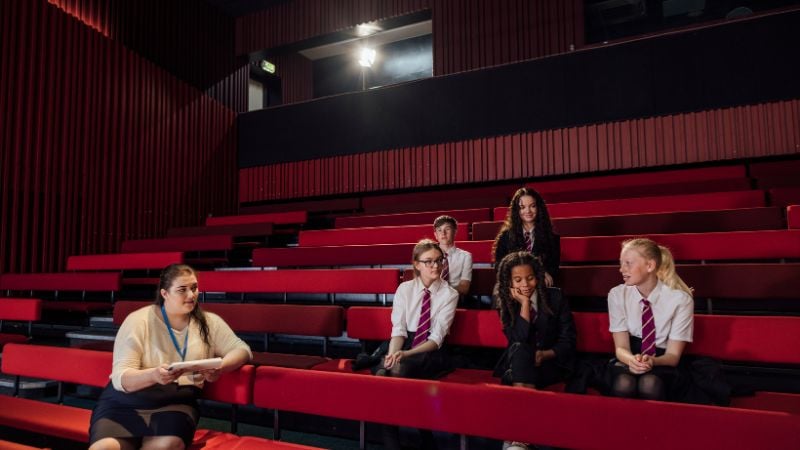 Students sitting in the theatre stalls.