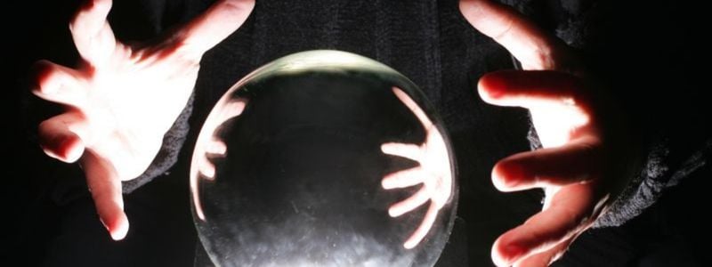 A fortune teller's hands around a crystal ball.