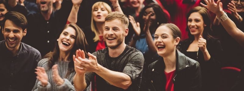 An audience laughing and participating in the show.