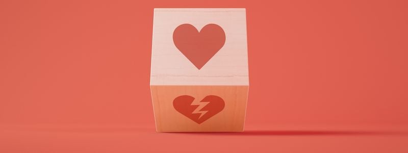 A cube with a heart and a broken heart on it.