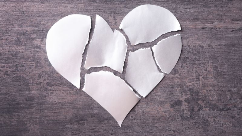 A paper heart ripped into six pieces.